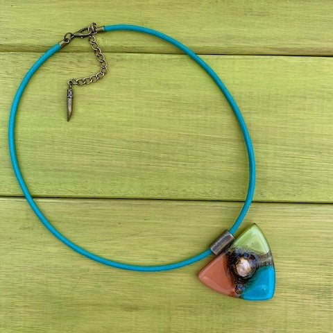 fashion fused glass triangle pendant on a leather cord in aqua green, orange and yellow colors